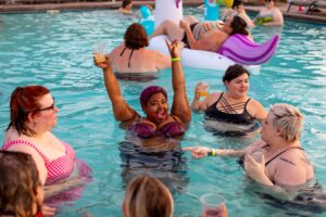 A Brief History of the Fat Acceptance Movement - A group of six fat folks in the water at a pool party